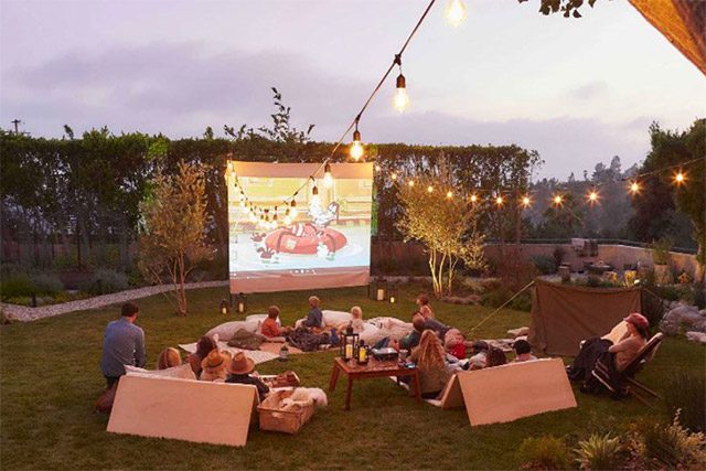 A group of people watching an outdoor movie