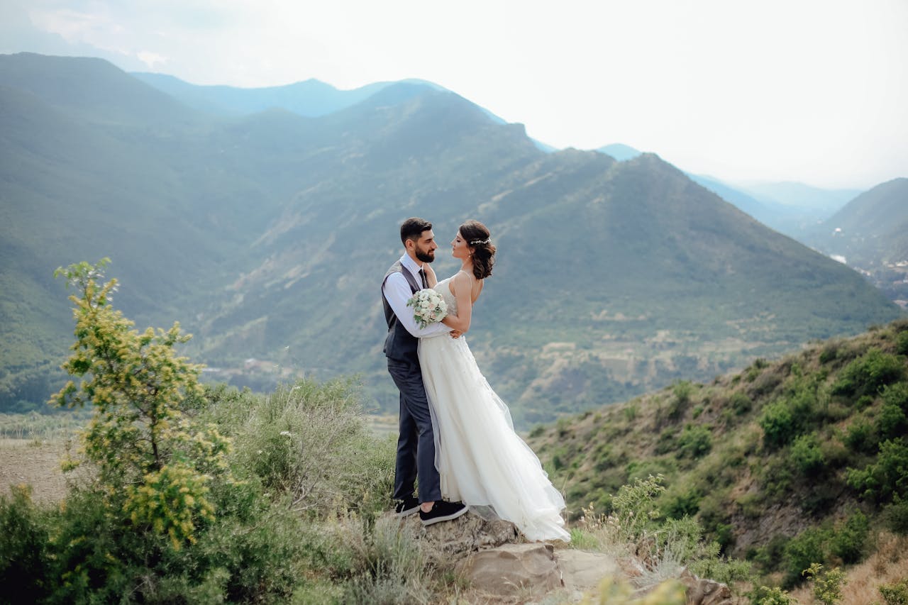 A bride and groom on a scenic mountain