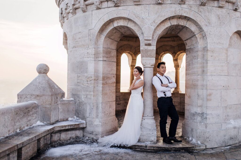 A bride and groom on top of a castle