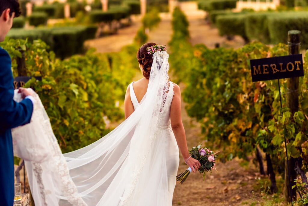 A bride walking through a vineyard