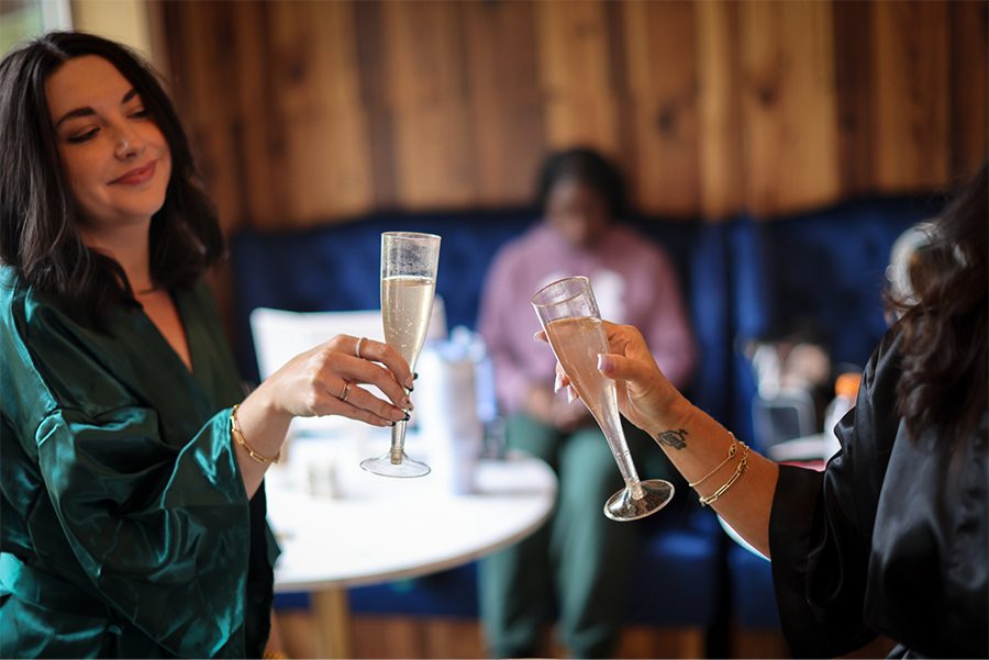 Two women toasting champagne in the bridal suite