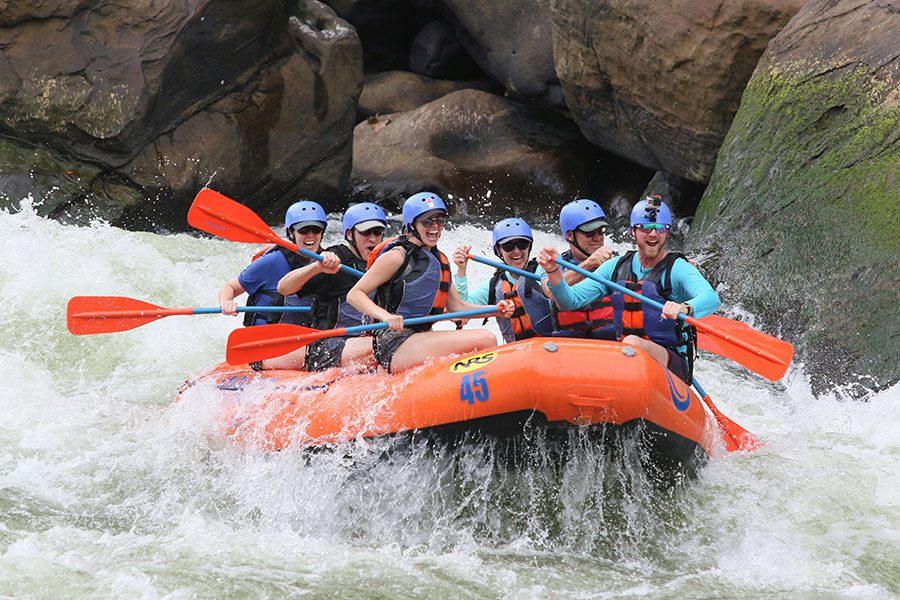 A group of people white water rafting