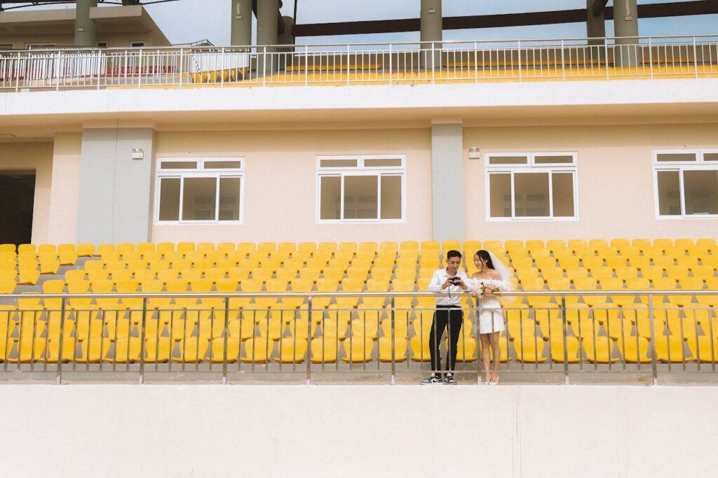 A bride and groom at a sports stadium