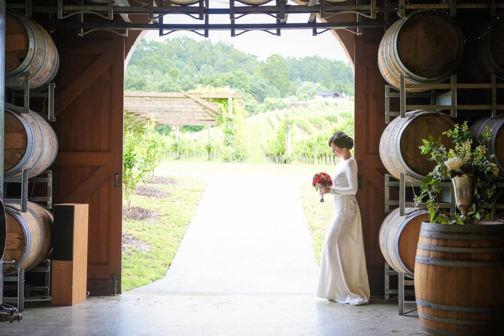 A bride standing in the doorway of a winery