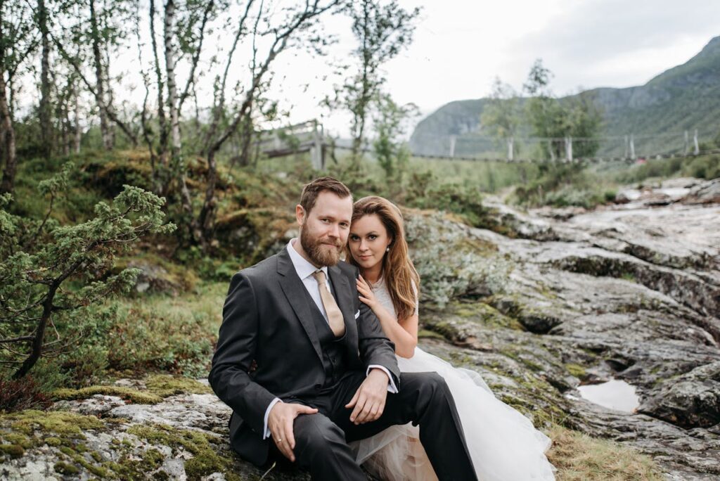 A bride and groom sitting in nature