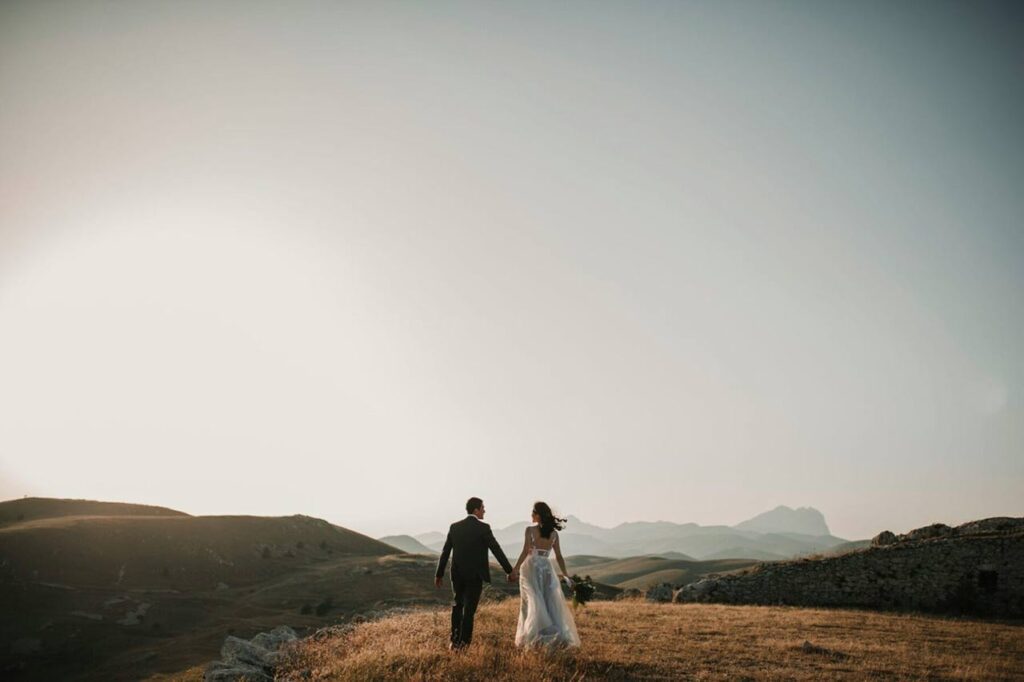 Newlyweds walking in a scenic outdoor area